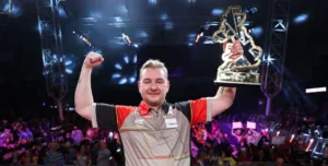 Dimitri van den Bergh lifts the UK Open Trophy for the first time